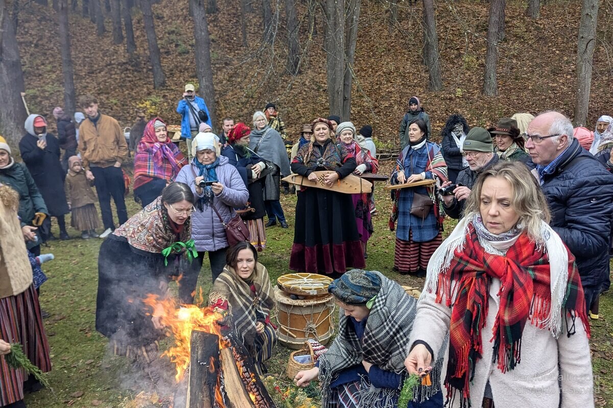 Visiteurs en costume traditionnel letton autour d'un feu de joie à la Saint-Martin, Musée ethnographique en plein air de Riga.