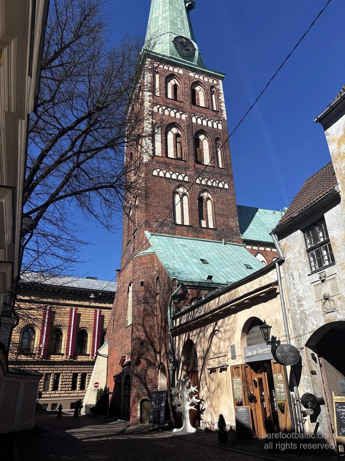 St James's Cathedral (Sv. Jēkaba katedrāle) on Jēkaba iela in Riga Old Town, Latvia — tall slim Gothic spire over a brick body.